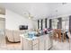 Open-concept kitchen with an island sink, flowing into the living and dining areas for seamless entertaining at 11606 W Laurelwood Ln, Avondale, AZ 85392