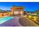 View of the large in-ground pool, a patio, covered patio, and desert landscaping in the backyard at 12015 S Tuzigoot Dr, Phoenix, AZ 85044
