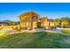 A spacious backyard with a manicured lawn, covered patio, and pool provide the perfect outdoor oasis at 12015 S Tuzigoot Dr, Phoenix, AZ 85044