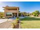 Expansive back yard with lush green lawn, a patio, and views of the surrounding landscape at 12015 S Tuzigoot Dr, Phoenix, AZ 85044