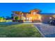 Spacious backyard with a large lawn, patio, and elegant home exterior at 12015 S Tuzigoot Dr, Phoenix, AZ 85044