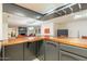 A well-appointed basement bar area features granite countertop, and custom cabinetry at 12015 S Tuzigoot Dr, Phoenix, AZ 85044