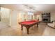 Spacious finished basement with a pool table, living area, and stairs leading to the upper level at 12015 S Tuzigoot Dr, Phoenix, AZ 85044