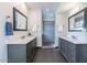 Stylish bathroom featuring dual vanities with white countertops and a glass-enclosed shower at 12015 S Tuzigoot Dr, Phoenix, AZ 85044