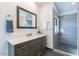 Bathroom vanity with white countertop and gray cabinetry, with a view of the shower at 12015 S Tuzigoot Dr, Phoenix, AZ 85044