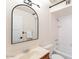 All-white bathroom with shower and tub combo and arched mirror at 12015 S Tuzigoot Dr, Phoenix, AZ 85044