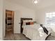 Cozy bedroom features a comfortable bed, a closet with shelving, and a window for natural light at 12015 S Tuzigoot Dr, Phoenix, AZ 85044