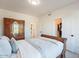 Bedroom featuring wood floors, a large window, and a decorative bed frame at 12015 S Tuzigoot Dr, Phoenix, AZ 85044