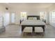Bright, minimalist bedroom with neutral tones, light wood floors, and plenty of natural light at 12015 S Tuzigoot Dr, Phoenix, AZ 85044