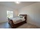 Bedroom featuring wood floors, a large window, and a decorative bed frame at 12015 S Tuzigoot Dr, Phoenix, AZ 85044