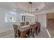 Bright dining room with wood table and seating for six and an elegant chandelier at 12015 S Tuzigoot Dr, Phoenix, AZ 85044