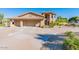 Handsome two-story home featuring a three-car garage, a paver driveway, and well-maintained front yard at 12015 S Tuzigoot Dr, Phoenix, AZ 85044
