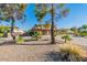 Lovely exterior view of a two-story home with a three-car garage, lush plants, and a tree at 12015 S Tuzigoot Dr, Phoenix, AZ 85044