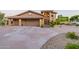 Inviting exterior featuring a spacious three-car garage, tiled roof, and desert landscaping at 12015 S Tuzigoot Dr, Phoenix, AZ 85044