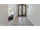 Inviting foyer showcasing a decorative iron double door and durable laminate flooring at 12015 S Tuzigoot Dr, Phoenix, AZ 85044