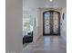 Entryway with a unique door, neutral wall, and a glimpse into the home's interior at 12015 S Tuzigoot Dr, Phoenix, AZ 85044