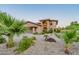 Stunning front exterior of the home with desert landscaping and a circular driveway at 12015 S Tuzigoot Dr, Phoenix, AZ 85044