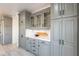 This kitchen features gray cabinets, white marble countertops, and stainless steel appliances at 12015 S Tuzigoot Dr, Phoenix, AZ 85044