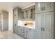 Kitchen with light gray cabinets, glass door accents, and white countertops at 12015 S Tuzigoot Dr, Phoenix, AZ 85044
