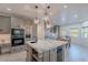 Modern kitchen with a central island, updated appliances, and an adjacent dining area at 12015 S Tuzigoot Dr, Phoenix, AZ 85044