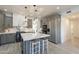 Modern kitchen featuring sleek countertops, stainless steel appliances, and a stylish center island with seating at 12015 S Tuzigoot Dr, Phoenix, AZ 85044