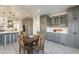 Open-concept kitchen and dining area with gray cabinetry and a wooden dining table at 12015 S Tuzigoot Dr, Phoenix, AZ 85044