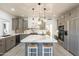 Bright kitchen showcasing a marble island, modern appliances, and custom cabinetry at 12015 S Tuzigoot Dr, Phoenix, AZ 85044
