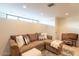 Cozy living room with sectional sofa, ottoman, and large window at 12015 S Tuzigoot Dr, Phoenix, AZ 85044