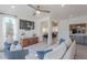 Open-concept living room with wood floors, a TV, and access to other living spaces at 12015 S Tuzigoot Dr, Phoenix, AZ 85044