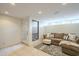 Cozy living room features a comfortable couch, ottoman, area rug, and plenty of natural light at 12015 S Tuzigoot Dr, Phoenix, AZ 85044