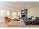 Inviting living room featuring a brick fireplace, comfortable seating, and access to the outdoors at 12015 S Tuzigoot Dr, Phoenix, AZ 85044