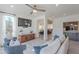 Bright living room featuring a large window, comfortable seating, and wood-look floors at 12015 S Tuzigoot Dr, Phoenix, AZ 85044
