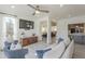 Bright living room with stylish seating, a ceiling fan, and seamless flow to other rooms at 12015 S Tuzigoot Dr, Phoenix, AZ 85044