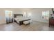 Generous main bedroom with bright windows, wood floors, and comfortable furnishings at 12015 S Tuzigoot Dr, Phoenix, AZ 85044