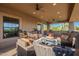 Relaxing covered patio area with comfortable seating and ceiling fans at 12015 S Tuzigoot Dr, Phoenix, AZ 85044