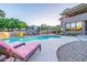 Backyard swimming pool with lounge chairs, beautiful landscaping, and mountain views at 12015 S Tuzigoot Dr, Phoenix, AZ 85044