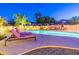 Inviting backyard pool with lounge chairs and lush landscaping, perfect for relaxing evenings at 12015 S Tuzigoot Dr, Phoenix, AZ 85044