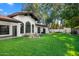 Landscaped backyard with artificial turf and a view of the home's exterior at 12286 N 86Th Pl, Scottsdale, AZ 85260