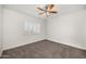 Bright bedroom featuring a ceiling fan and neutral carpeting at 12286 N 86Th Pl, Scottsdale, AZ 85260