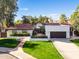 Single-story home with red tile roof, landscaped yard, and two-car garage at 12286 N 86Th Pl, Scottsdale, AZ 85260