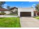 House exterior showcasing a brown garage door and well-manicured lawn at 12286 N 86Th Pl, Scottsdale, AZ 85260