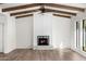 Living room fireplace with marble surround and wood beams at 12286 N 86Th Pl, Scottsdale, AZ 85260