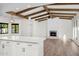 Kitchen with white cabinets, island, and exposed wooden beams at 12286 N 86Th Pl, Scottsdale, AZ 85260