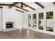 Bright living room with fireplace, hardwood floors, and large windows at 12286 N 86Th Pl, Scottsdale, AZ 85260