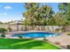 Inviting kidney-shaped pool surrounded by lush landscaping at 12286 N 86Th Pl, Scottsdale, AZ 85260