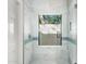 Updated shower with marble tile and a window providing natural light at 12286 N 86Th Pl, Scottsdale, AZ 85260