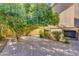 Paved patio backyard with mature trees and lush landscaping at 12465 N 71St Ave, Peoria, AZ 85381