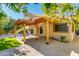 Backyard patio with pergola and grassy area at 12465 N 71St Ave, Peoria, AZ 85381