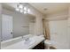 Bathroom with tub, single sink vanity and beige walls at 12465 N 71St Ave, Peoria, AZ 85381