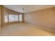 Bright bedroom with large window and carpeted floor at 12465 N 71St Ave, Peoria, AZ 85381
